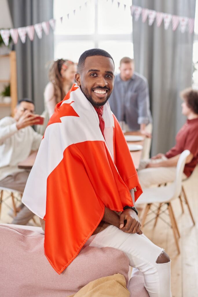 A Man Sitting on a Chair with a Canadian Flag