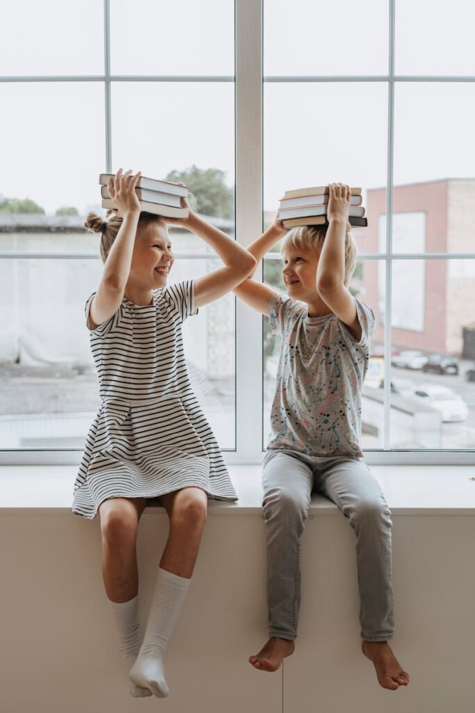 Brother and Sister With Books on Their Heads